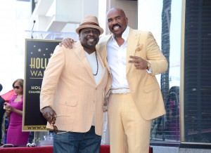 Actor and radio host Steve Harvey (R) poses on his star on the Hollywood Walk of Fame with comedian Cedric the Entertainer 